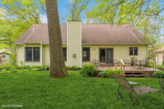 18855 Lonergan St, New Buffalo, MI 49117 - rear view of house featuring a wooden deck, a chimney, a lawn, and roof with shingles