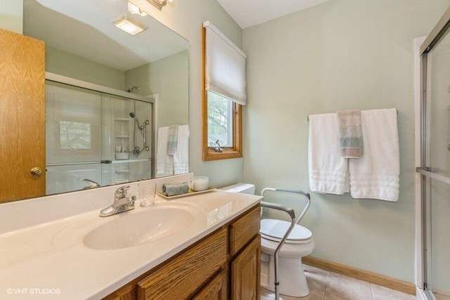18855 Lonergan St, New Buffalo, MI 49117 - bathroom featuring a stall shower, toilet, tile patterned floors, vanity, and baseboards