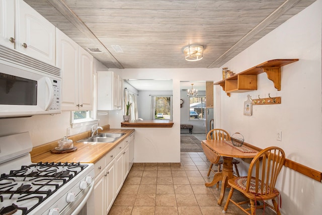 2574 S Lake Pleasant Rd, Metamora, MI 48455 - kitchen featuring white appliances, a sink, a chandelier, and white cabinets