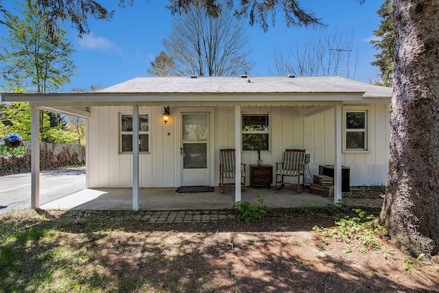 2574 S Lake Pleasant Rd, Metamora, MI 48455 - back of property featuring central air condition unit, board and batten siding, and a porch