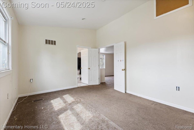 18965 Rutherford St, Detroit, MI 48235 - carpeted empty room featuring plenty of natural light, baseboards, and vaulted ceiling