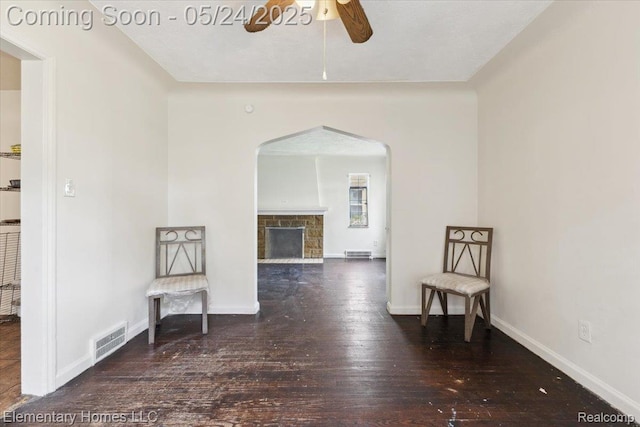 18965 Rutherford St, Detroit, MI 48235 - unfurnished room featuring a ceiling fan, arched walkways, wood finished floors, a fireplace, and baseboards