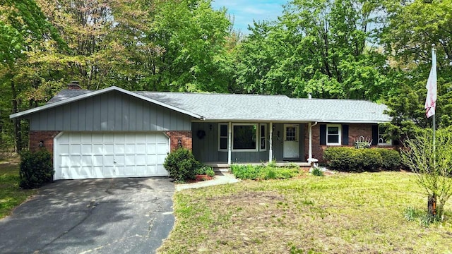 2967 152nd Ave, Holland, MI 49424 - ranch-style house featuring brick siding, a porch, driveway, and a garage