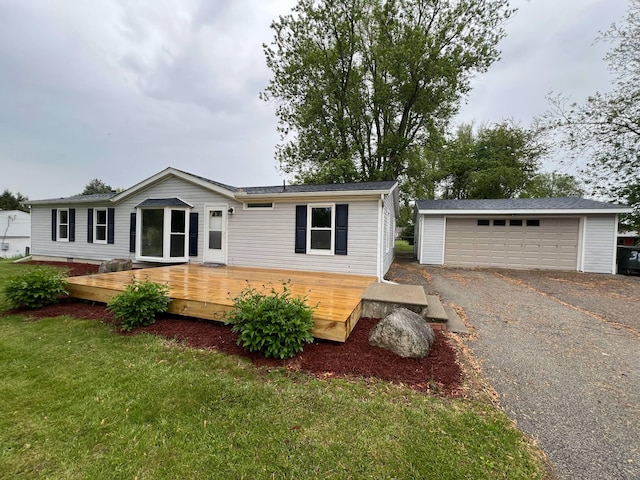 3820 Kaiser Rd, Tecumseh, MI 49286 - view of front facade featuring a garage, an outbuilding, a deck, and a front yard