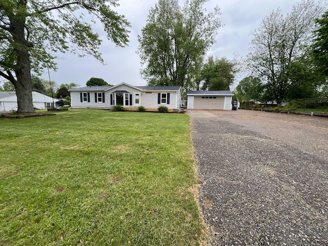 3820 Kaiser Rd, Tecumseh, MI 49286 - view of front facade with an outdoor structure, a garage, a front yard, and gravel driveway