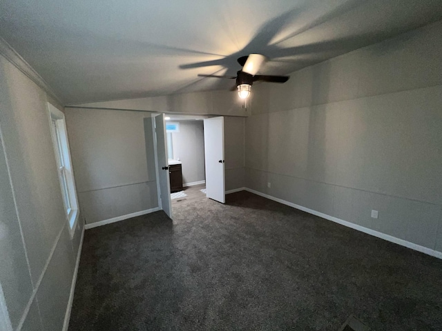 3820 Kaiser Rd, Tecumseh, MI 49286 - unfurnished bedroom with lofted ceiling, dark carpet, baseboards, and a ceiling fan