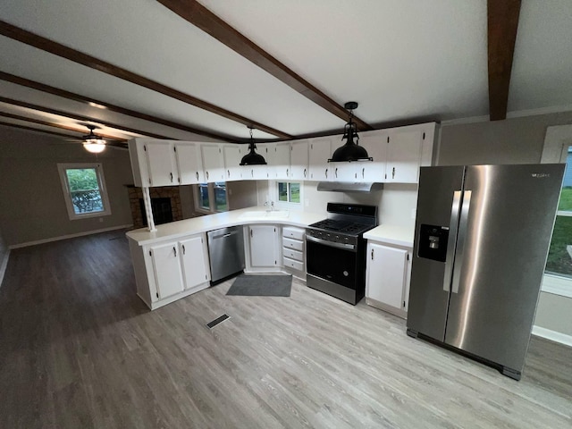 3820 Kaiser Rd, Tecumseh, MI 49286 - kitchen featuring stainless steel appliances, a sink, beamed ceiling, light wood-style flooring, and a peninsula
