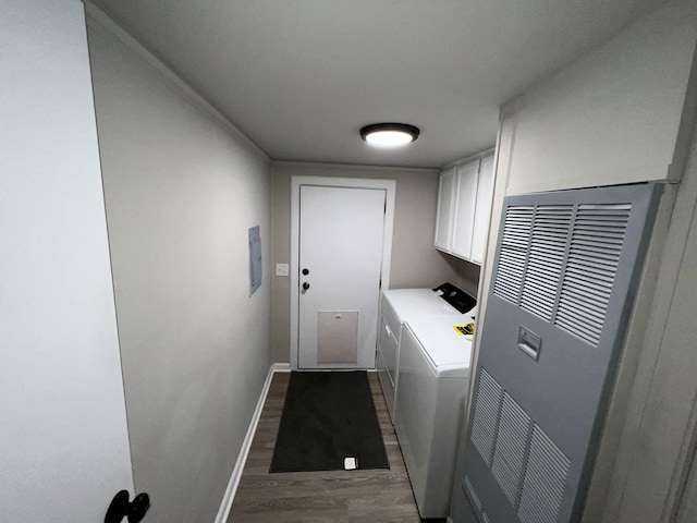 3820 Kaiser Rd, Tecumseh, MI 49286 - laundry room featuring separate washer and dryer, a heating unit, cabinet space, wood finished floors, and baseboards