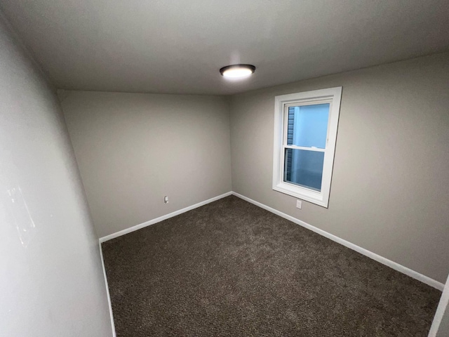 3820 Kaiser Rd, Tecumseh, MI 49286 - spare room featuring dark carpet and baseboards