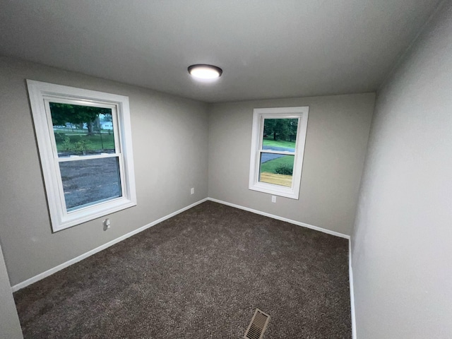 3820 Kaiser Rd, Tecumseh, MI 49286 - spare room with dark carpet and baseboards