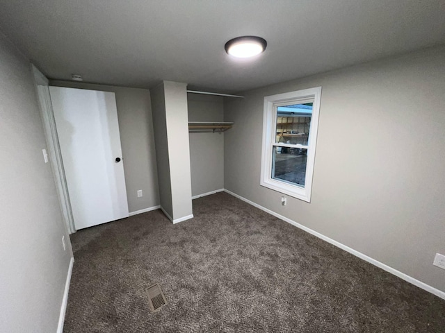 3820 Kaiser Rd, Tecumseh, MI 49286 - unfurnished bedroom featuring a closet, carpet floors, and baseboards