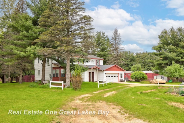 4080 Cat Lake Rd, Mayville, MI 48744 - view of front of home featuring an attached garage, dirt driveway, and a front lawn