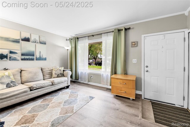 33117 Avondale St, Westland, MI 48186 - living area featuring crown molding, wood finished floors, and baseboards