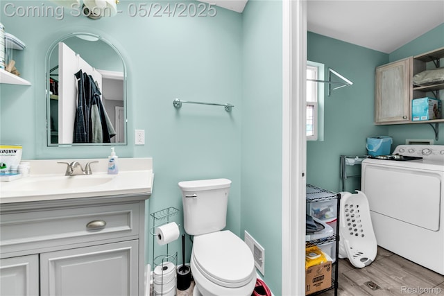 33117 Avondale St, Westland, MI 48186 - bathroom featuring washer / dryer, vanity, wood finished floors, and toilet