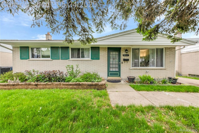 33117 Avondale St, Westland, MI 48186 - view of front of property featuring brick siding, a chimney, and a front yard