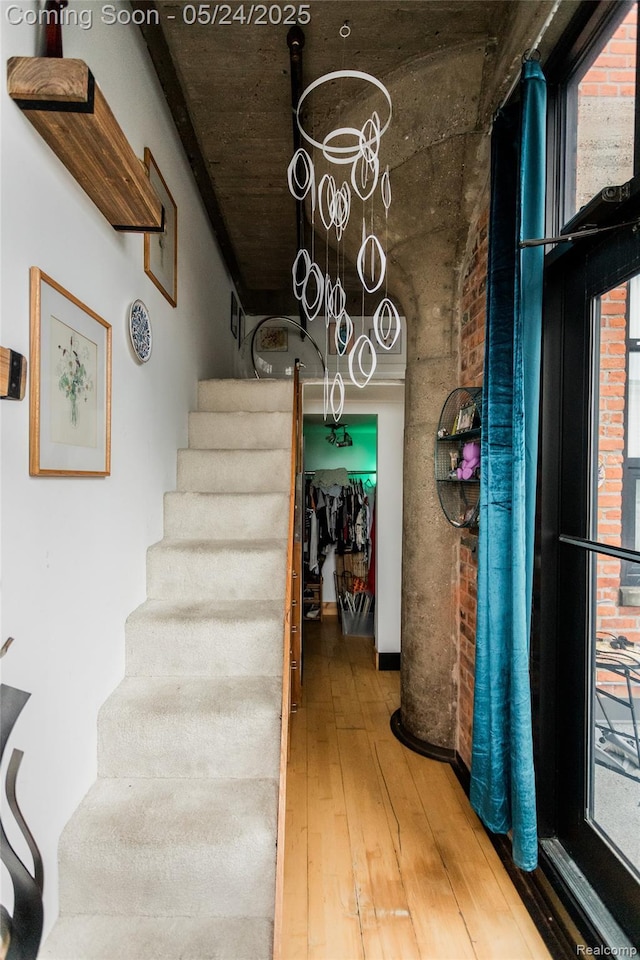 460 W Canfield St # 212/Unit 21, Detroit, MI 48201 - stairway featuring hardwood / wood-style flooring and a chandelier