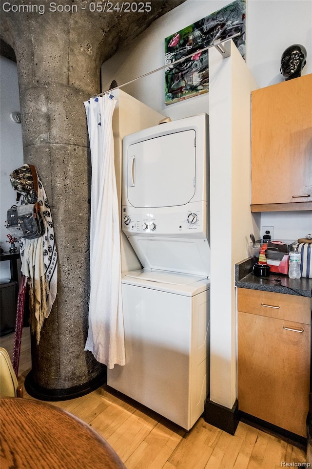 460 W Canfield St # 212/Unit 21, Detroit, MI 48201 - laundry area with stacked washer and clothes dryer and light wood-style flooring