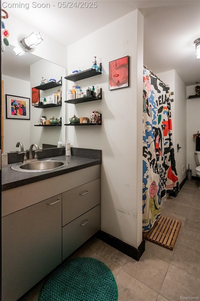 460 W Canfield St # 212/Unit 21, Detroit, MI 48201 - bar with a sink, dark tile patterned flooring, and baseboards