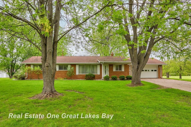 5354 N River Rd, Freeland, MI 48623 - single story home with concrete driveway, a chimney, an attached garage, and a front yard
