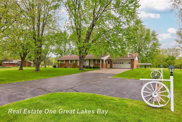 5354 N River Rd, Freeland, MI 48623 - view of front of property featuring asphalt driveway, an attached garage, a front lawn, and brick siding