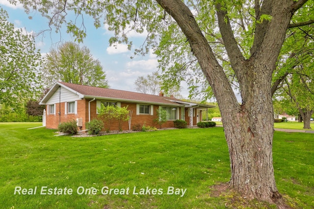 5354 N River Rd, Freeland, MI 48623 - ranch-style home with brick siding, a front lawn, and a chimney