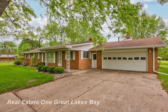 5354 N River Rd, Freeland, MI 48623 - single story home with brick siding, a front yard, concrete driveway, an attached garage, and a chimney