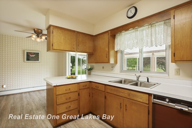 5354 N River Rd, Freeland, MI 48623 - kitchen featuring dishwashing machine, a sink, a peninsula, light countertops, and wallpapered walls