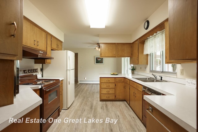 5354 N River Rd, Freeland, MI 48623 - kitchen with electric stove, under cabinet range hood, a sink, wallpapered walls, and light countertops