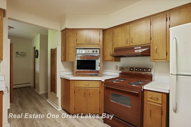 5354 N River Rd, Freeland, MI 48623 - kitchen with electric stove, freestanding refrigerator, stainless steel oven, under cabinet range hood, and a baseboard heating unit