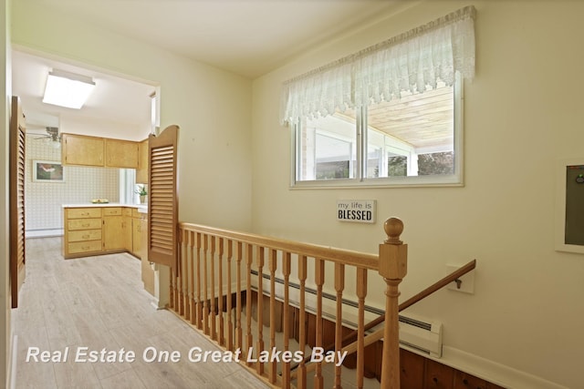 5354 N River Rd, Freeland, MI 48623 - hallway featuring an upstairs landing, light wood-type flooring, and baseboards