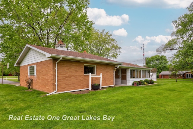 5354 N River Rd, Freeland, MI 48623 - back of house featuring a yard and brick siding