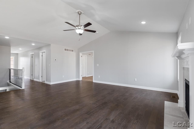 796 War Bonnet Dr, Tecumseh, MI 49286 - unfurnished living room featuring ceiling fan, a fireplace with flush hearth, vaulted ceiling, wood finished floors, and baseboards