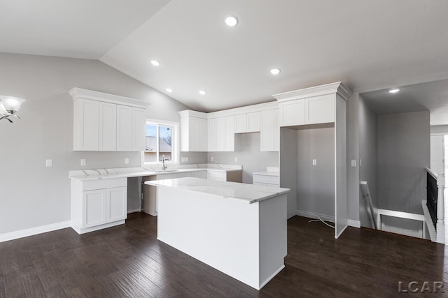 796 War Bonnet Dr, Tecumseh, MI 49286 - kitchen featuring a kitchen island, lofted ceiling, dark wood-type flooring, white cabinets, and recessed lighting