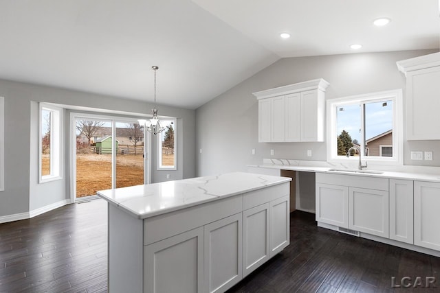 796 War Bonnet Dr, Tecumseh, MI 49286 - kitchen featuring a sink, vaulted ceiling, dark wood-style floors, a chandelier, and white cabinets