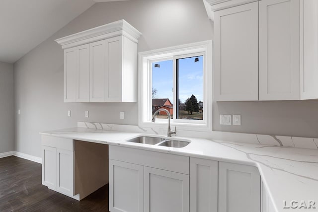 796 War Bonnet Dr, Tecumseh, MI 49286 - kitchen with a sink, dark wood-style flooring, light stone countertops, vaulted ceiling, and white cabinets