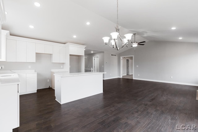 796 War Bonnet Dr, Tecumseh, MI 49286 - kitchen with a chandelier, a kitchen island, lofted ceiling, white cabinetry, and open floor plan