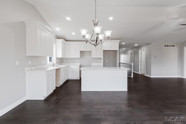 796 War Bonnet Dr, Tecumseh, MI 49286 - kitchen with a sink, a center island, baseboards, a chandelier, and dark wood-style floors