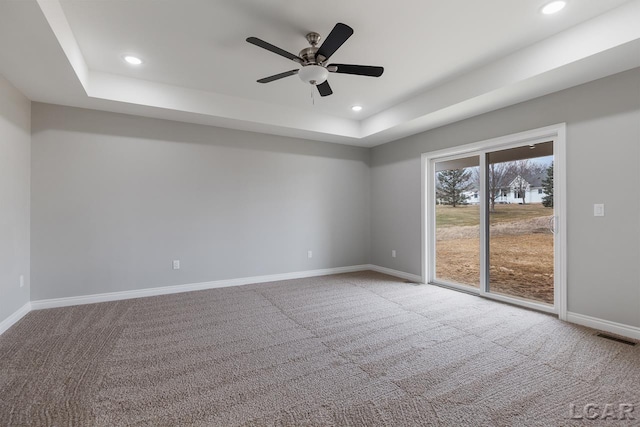 796 War Bonnet Dr, Tecumseh, MI 49286 - carpeted spare room featuring a raised ceiling, recessed lighting, baseboards, and a ceiling fan