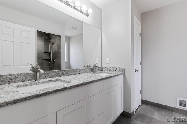 796 War Bonnet Dr, Tecumseh, MI 49286 - full bath with tile patterned flooring, a tile shower, double vanity, and baseboards
