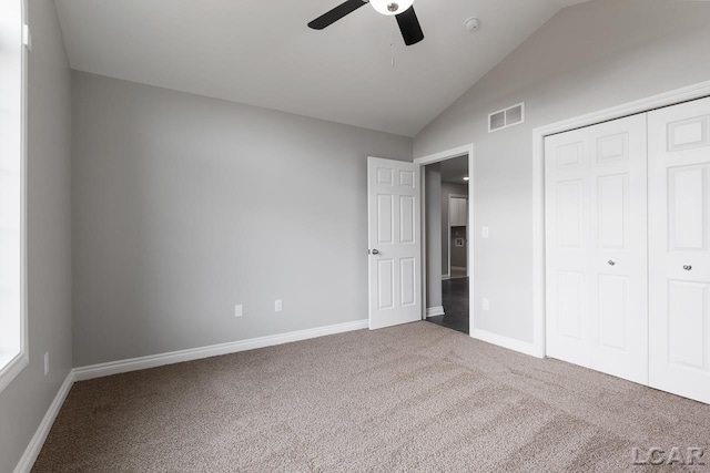 796 War Bonnet Dr, Tecumseh, MI 49286 - unfurnished bedroom featuring lofted ceiling, carpet floors, baseboards, a closet, and a ceiling fan