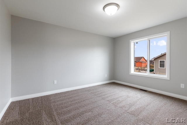 796 War Bonnet Dr, Tecumseh, MI 49286 - carpeted empty room with baseboards