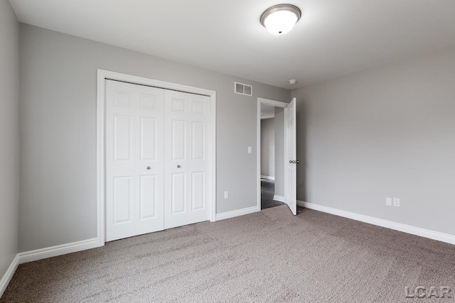 796 War Bonnet Dr, Tecumseh, MI 49286 - unfurnished bedroom with carpet floors, a closet, and baseboards