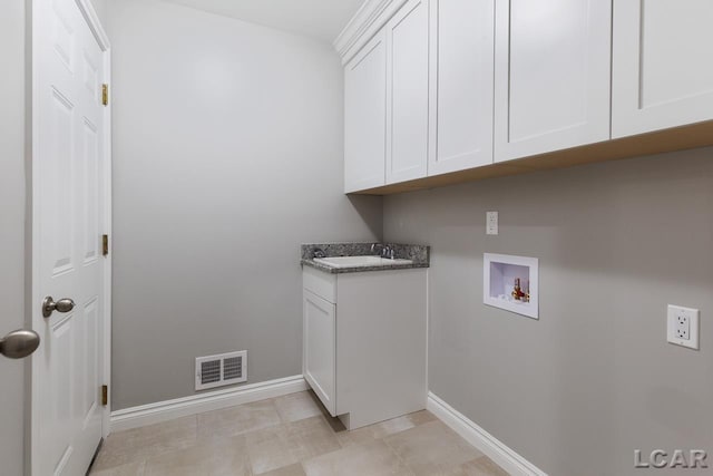 796 War Bonnet Dr, Tecumseh, MI 49286 - laundry area with hookup for a washing machine, baseboards, and cabinet space