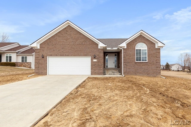 796 War Bonnet Dr, Tecumseh, MI 49286 - single story home with a garage, driveway, brick siding, and roof with shingles