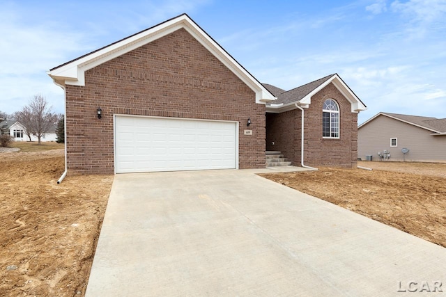 796 War Bonnet Dr, Tecumseh, MI 49286 - ranch-style home featuring brick siding, concrete driveway, and a garage