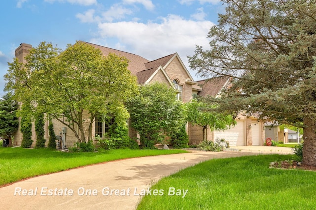 4168 Windemere Dr, Saginaw, MI 48603 - view of front of house featuring concrete driveway, brick siding, a garage, a front lawn, and roof with shingles