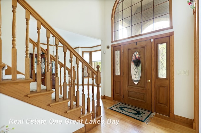 4168 Windemere Dr, Saginaw, MI 48603 - entryway with plenty of natural light, baseboards, wood finished floors, a towering ceiling, and stairs