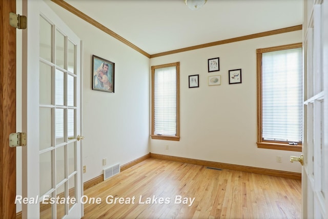 4168 Windemere Dr, Saginaw, MI 48603 - spare room featuring plenty of natural light, baseboards, light wood-style floors, and crown molding
