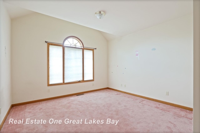 4168 Windemere Dr, Saginaw, MI 48603 - carpeted spare room featuring vaulted ceiling and baseboards