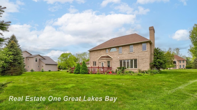 4168 Windemere Dr, Saginaw, MI 48603 - rear view of house with a chimney, a lawn, and a deck